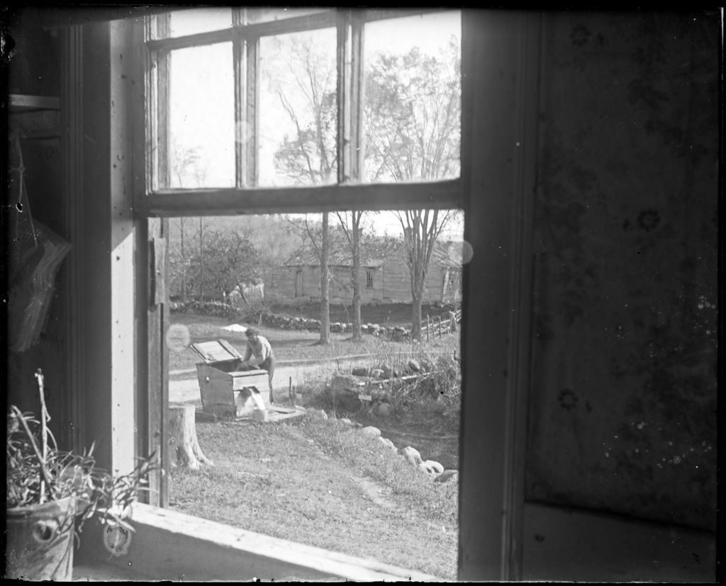 Miniature of View Through A Window Of A Man At A Well