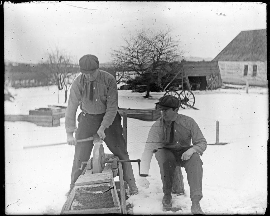 Miniature of Two Men Sharpening An Axe On A Grinding Wheel