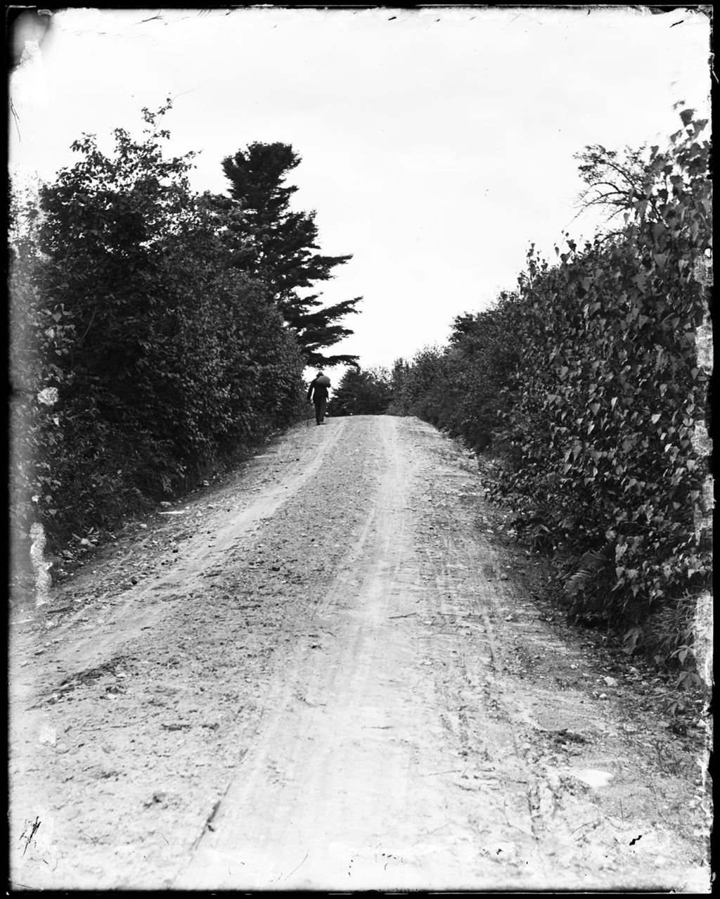 Miniature of Man Walking On A Rural Road & Carrying A Sack