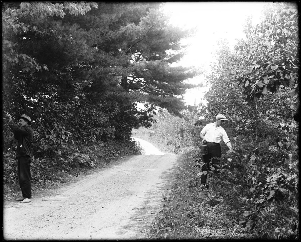 Miniature of Two Men Walking Along A Tree Lined Rural Road