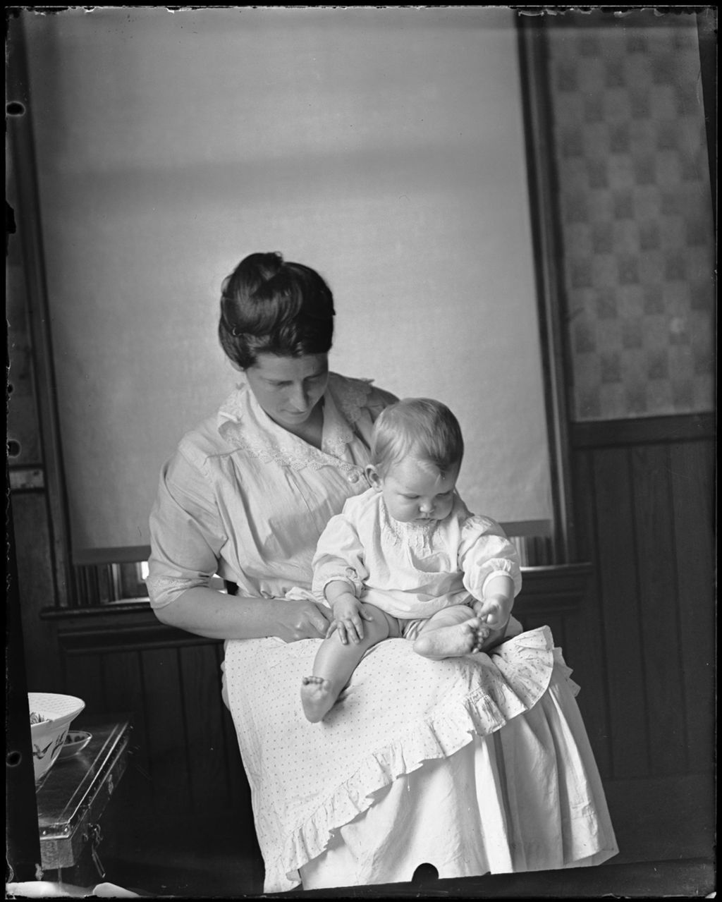 Miniature of Woman Sitting With A Baby On Her Lap.