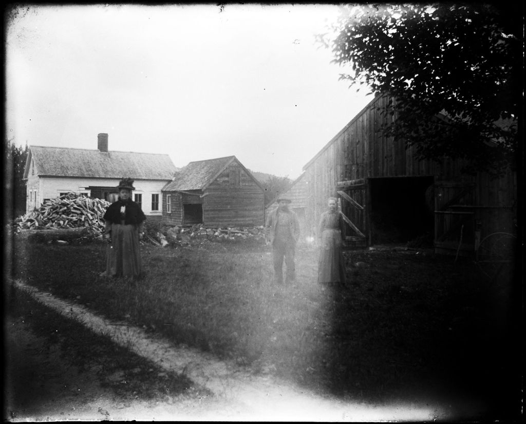 Miniature of People Standing Outside A House & Barn With Large Wood Pile