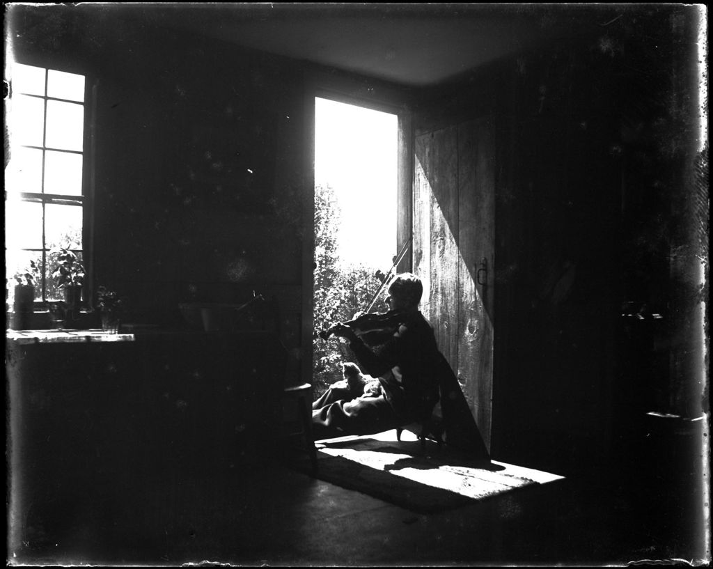 Miniature of Man Sitting In A Doorway Playing A Fiddle