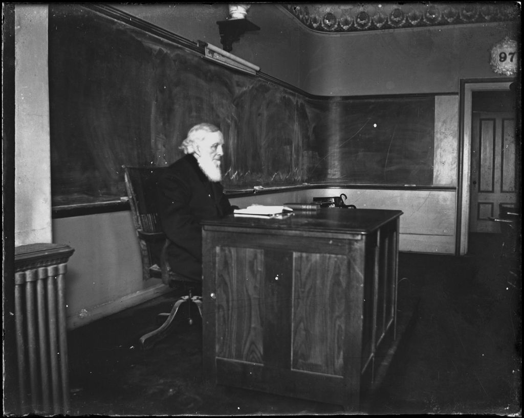 Miniature of College Professor Seated At His Desk In A Classroom (Bates College)
