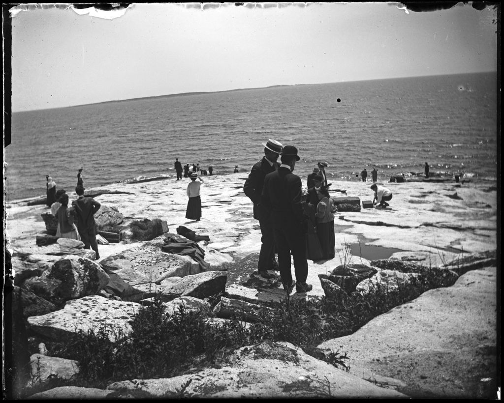 Miniature of Large Number Of People Gathered On A Rocky Shore