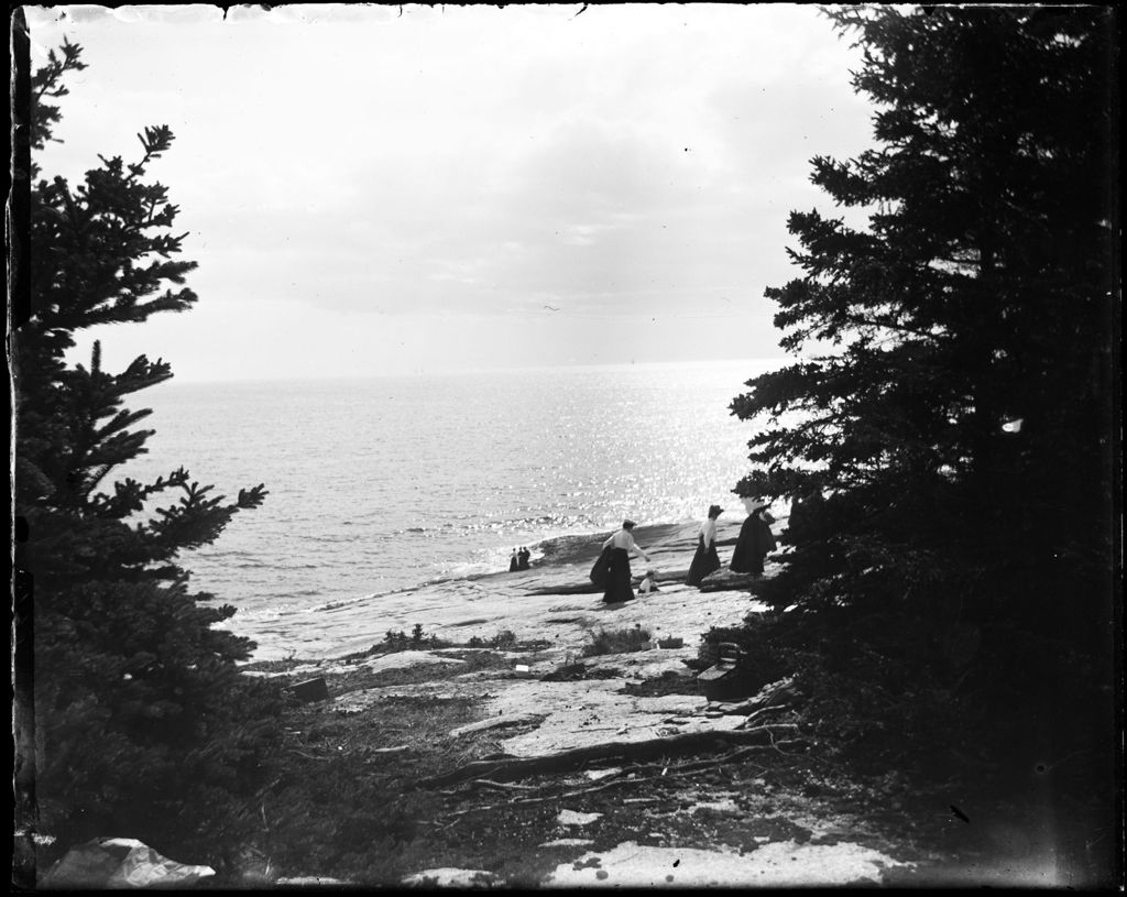 Miniature of People Walking On A Rocky Shore