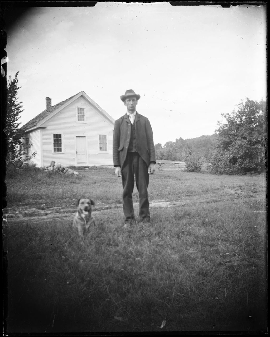 Miniature of A Man And His Dog Standing Outside His Home