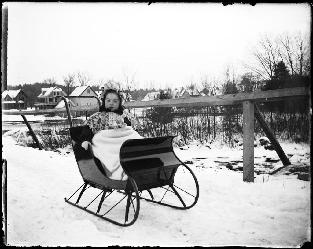 Miniature of Young Child Sitting In A Sleigh