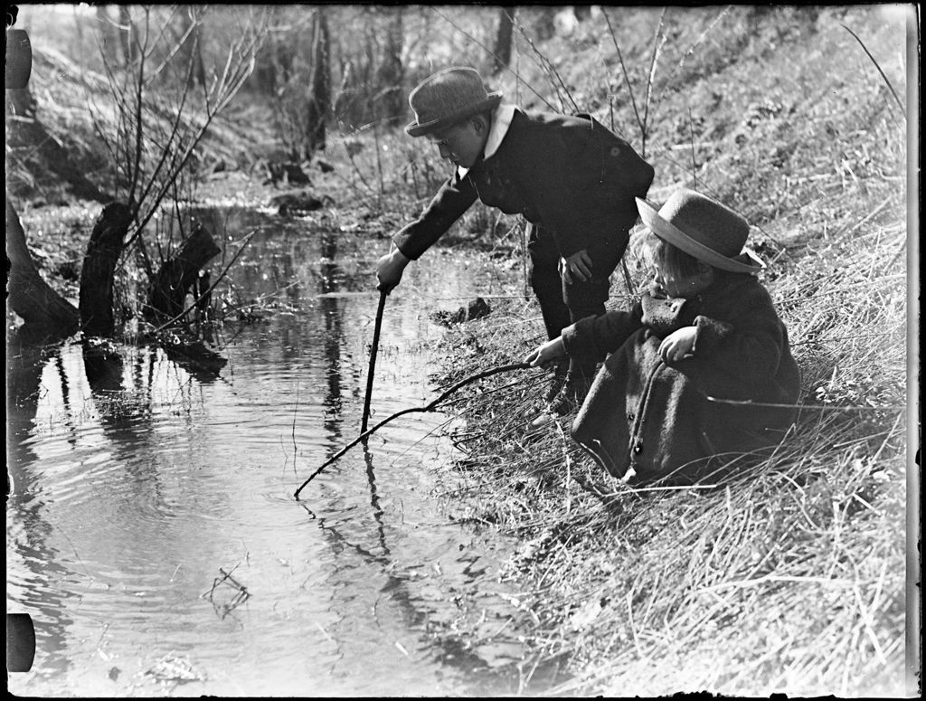 Miniature of Young Boy And Girl With Sticks Playing Beside A Stream