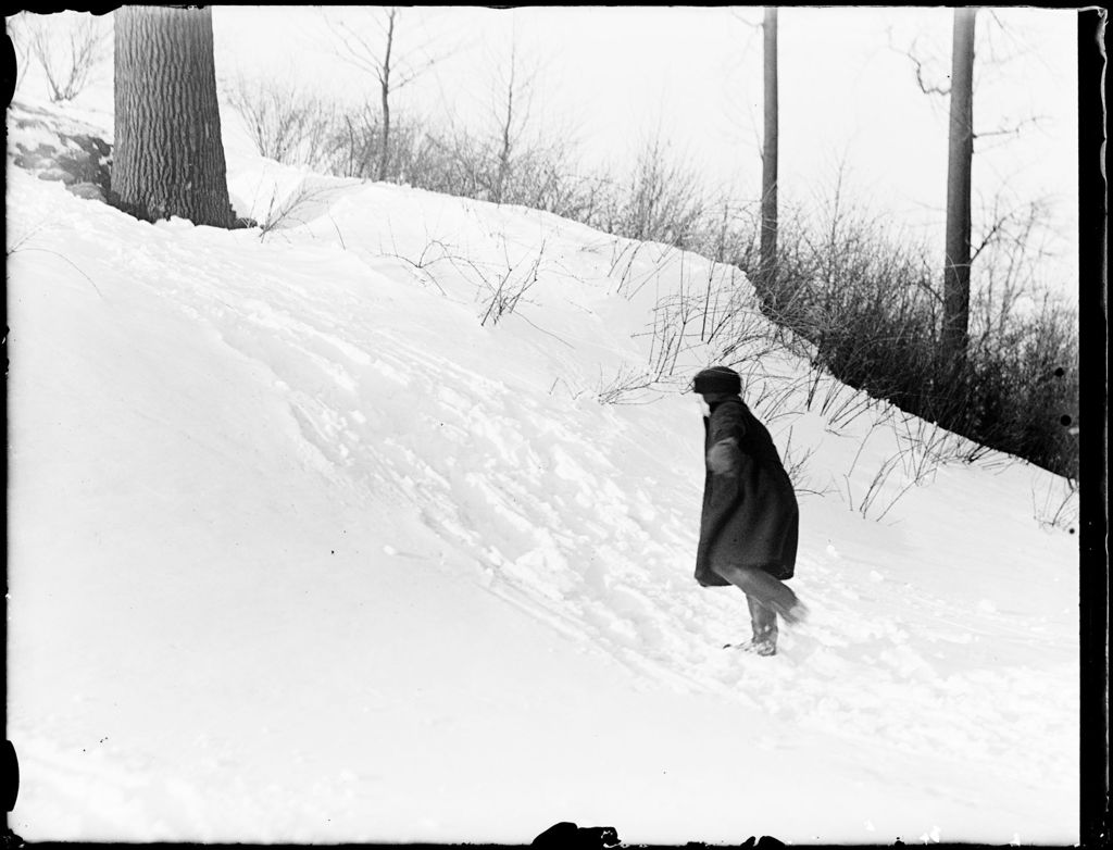 Miniature of Young Boy Climbing Up A Snowy Hill