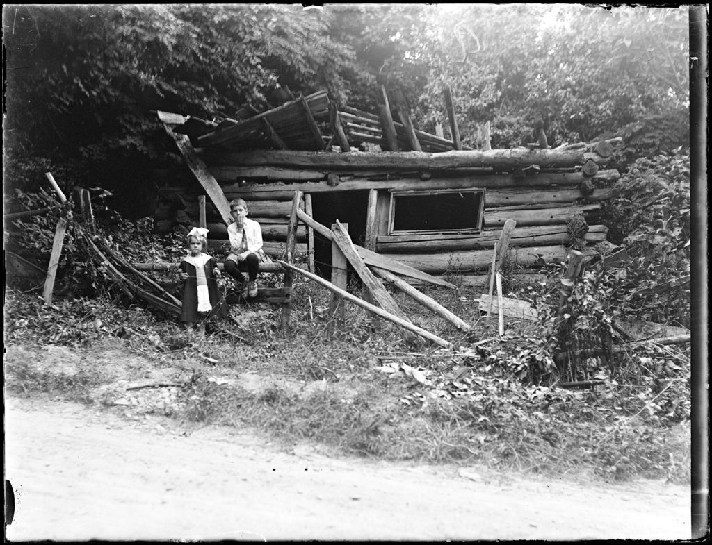 Miniature of Young Boy And Girl In Front Of A Falling Down Log Cabin