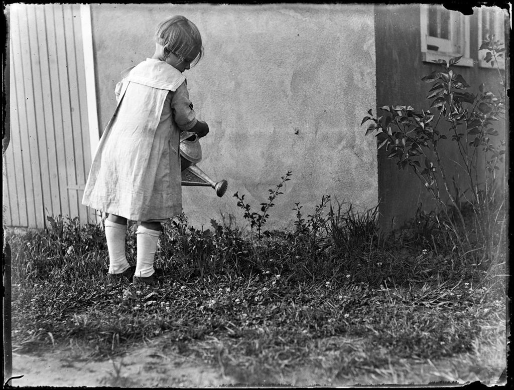 Miniature of Young Girl Watering Plants Outside A House