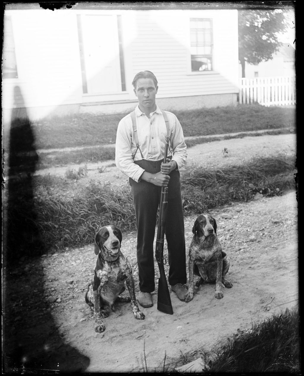 Miniature of Man With A Shotgun And Two Bird Dogs Standing Outside A House