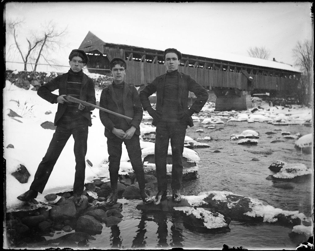 Miniature of Three Young Men On The Bank Of A River, One With A Shotgun, Covered Bridge In The Distance