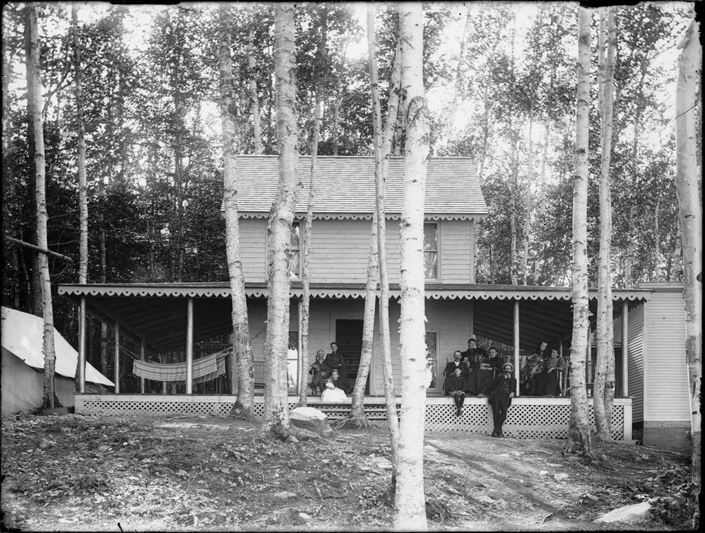 Miniature of Group of people posing on the covered porch of a camp in the woods