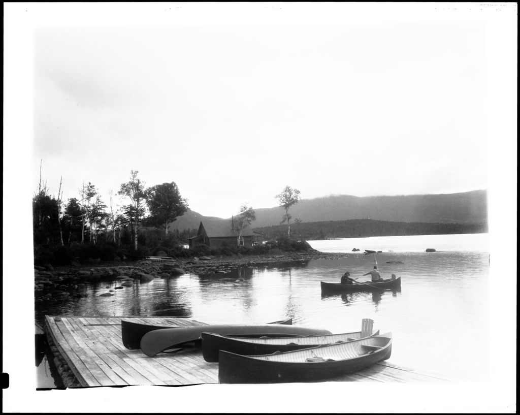 Miniature of Two Men In A Canoe Near A Small Inlet, Sky Dark And Threatening