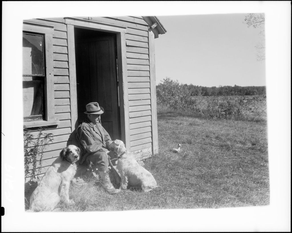 Miniature of Man Sitting On Doorstep With Two Dogs
