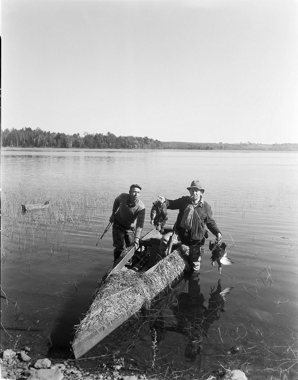 Miniature of Two Hunters In A Camouflaged Boat, Coming In From Duck Hunting