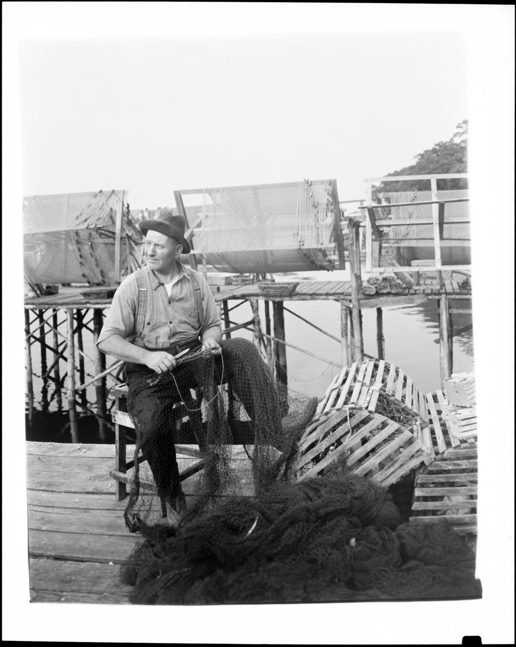 Miniature of Fisherman Sitting On Dock Repairing Fish Net In New Harbor