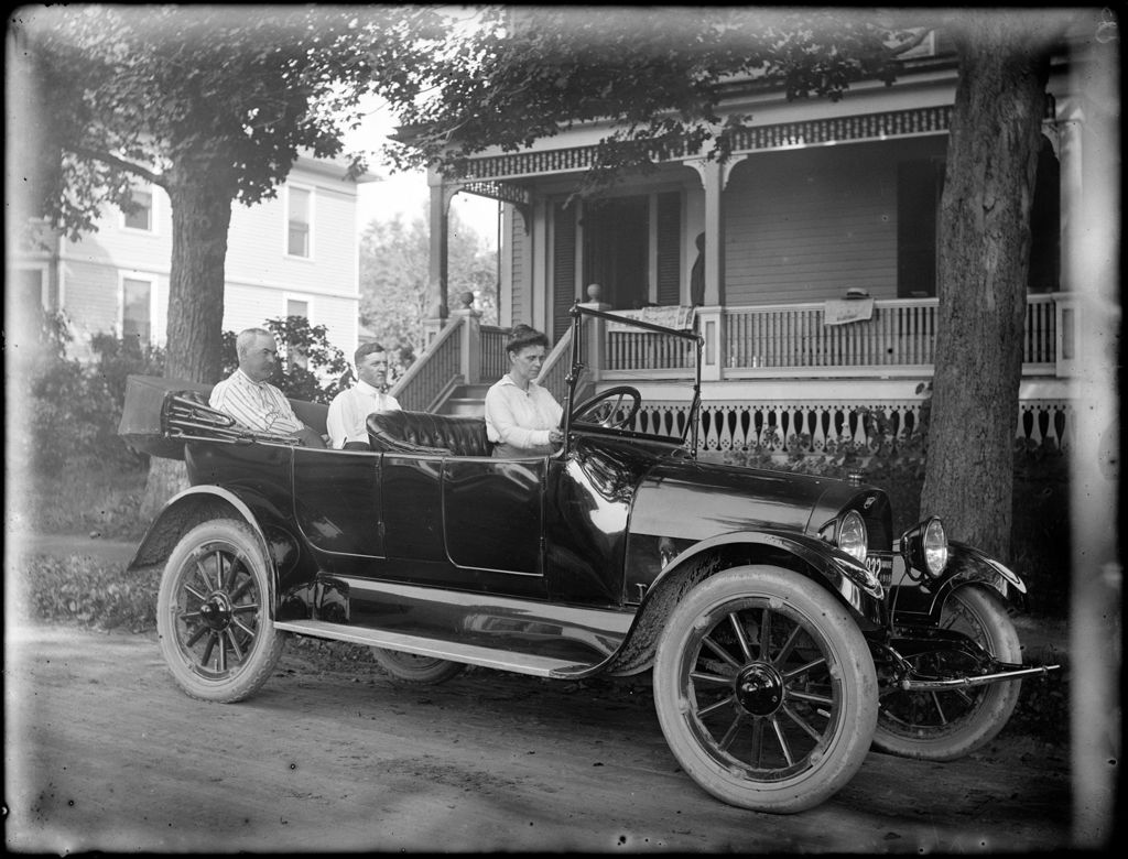 Miniature of Three People Sitting In An 'open Air' 4 Door Reo Car