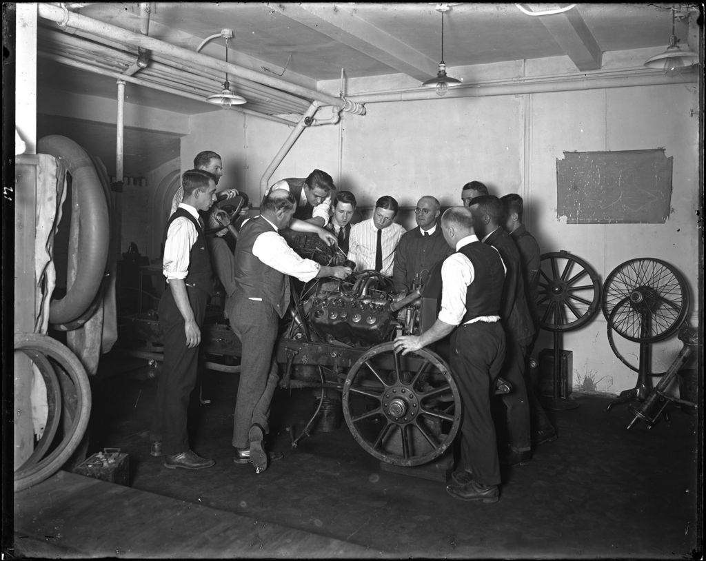 Miniature of Men Standing Around An Engine In An Auto Shop, Nj