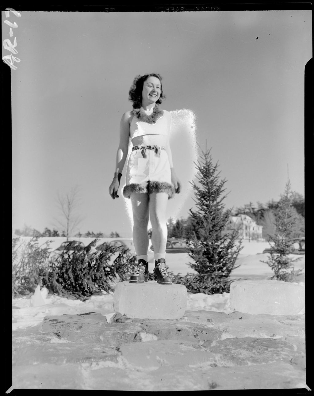 Miniature of Young Woman Wearing Shorts, Tank Top And Ski Boots Standing In Snow