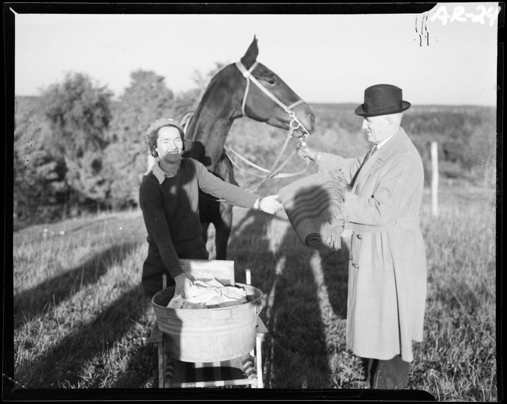 Miniature of Man And Woman Standing In Front Of A Horse