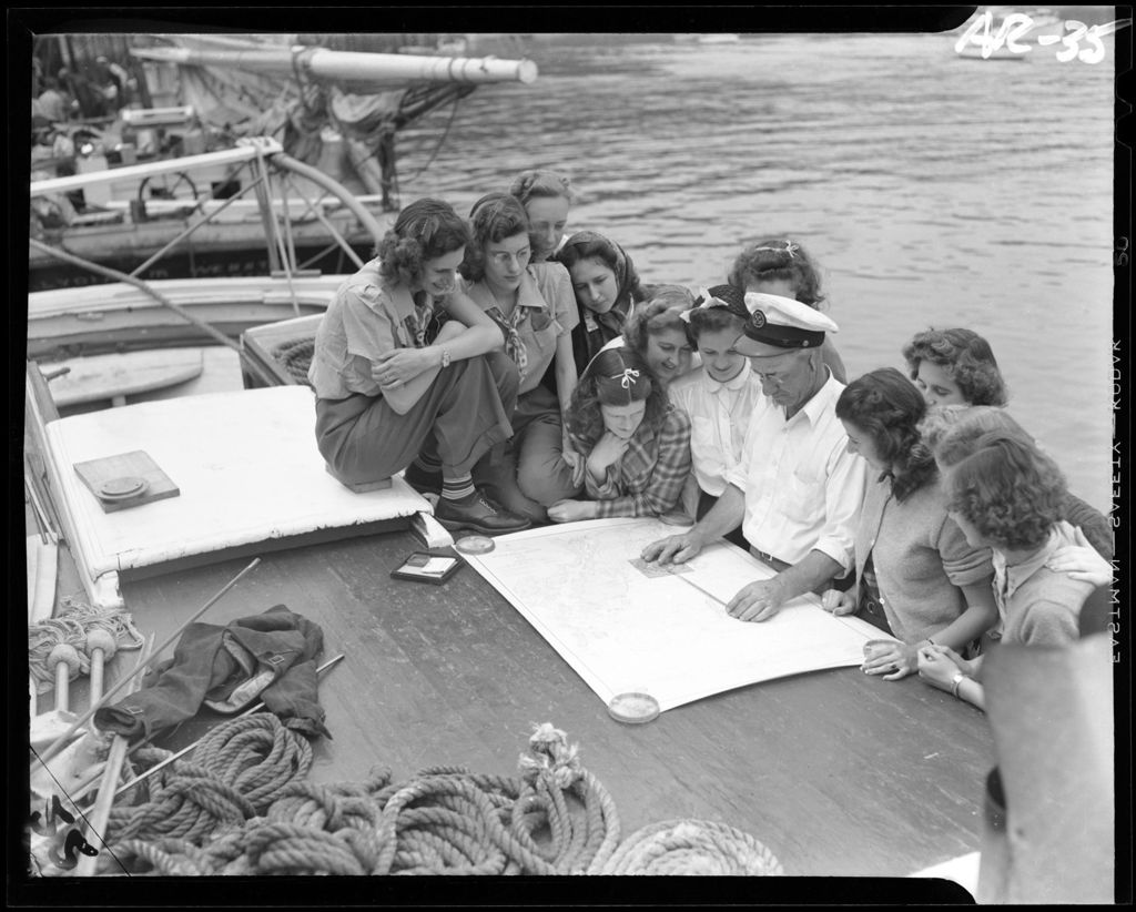 Miniature of Group Of Girls Standing With The Captain Of A Schooner While He Explains A Nautical Chart