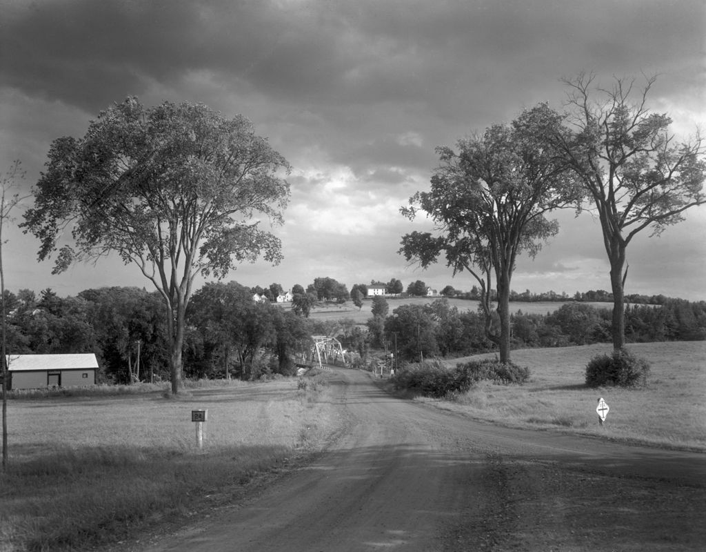 Miniature of Highway Leading Toward A Cluster Of Homes In Sangerville, Nice Clouds In Sky, Iron Bridge