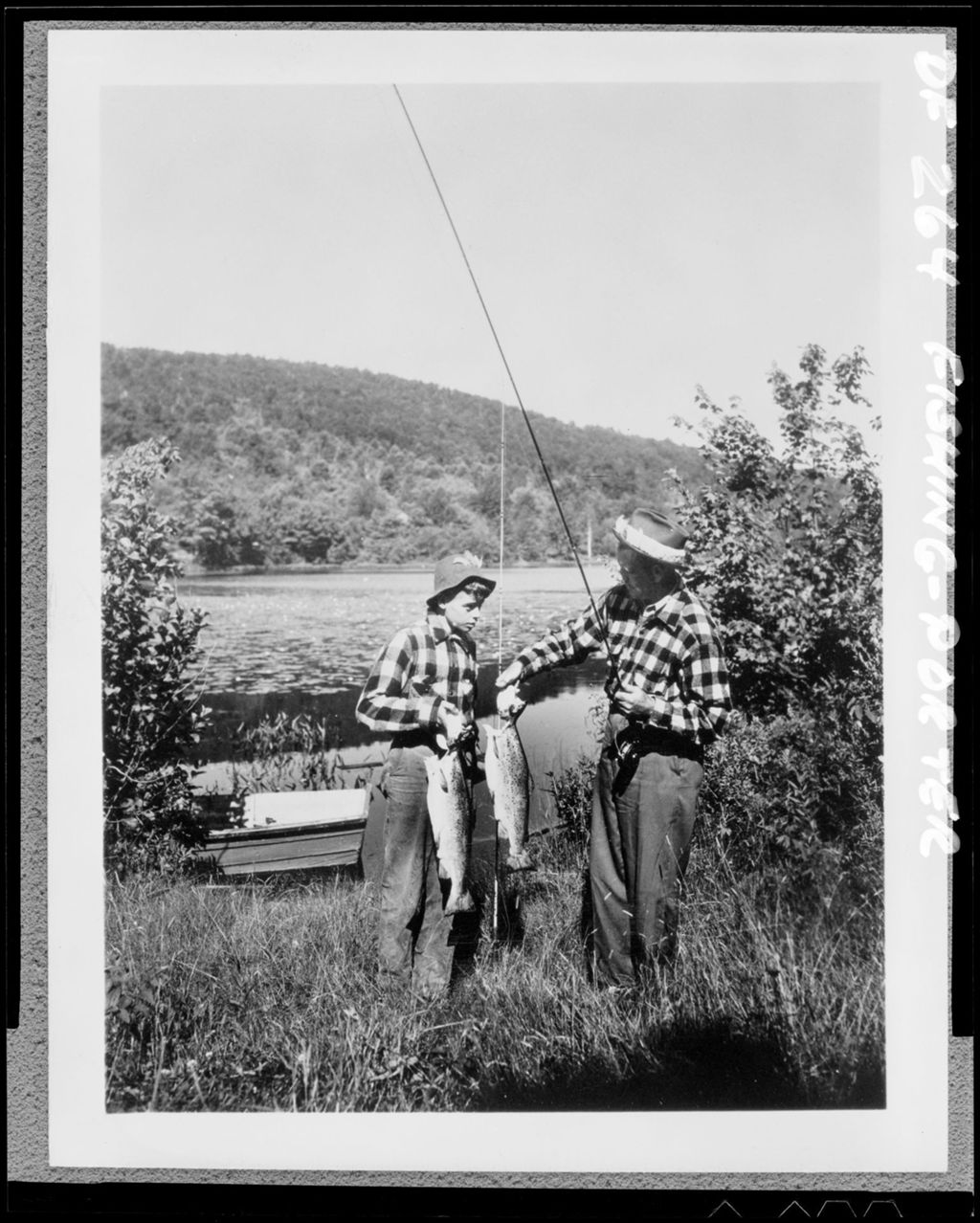 Miniature of Man And Woman Holding Two Bass In Porter