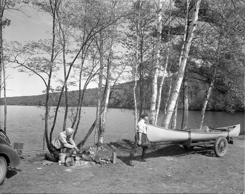 Miniature of Two Men Setting Up Camp By A Lake
